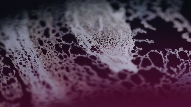 Fizzy fluid texture. Acid liquid. Defocused blue pink color oil emulsion leak puddle slick motion on dark black light flare abstract art background.