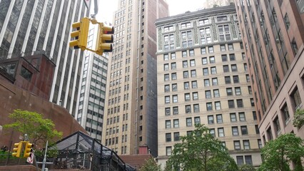 Fototapeta premium New York City Water street crossroad, yellow traffic light, transport road intersection, United States. NYC Lower Manhattan, downtown financial business district. Highrise skyscrapers. Gouverneur Ln.