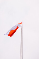 The Indonesian flag, red and white, waves gracefully in the wind. Perfect for themes of patriotism, national pride, and cultural identity