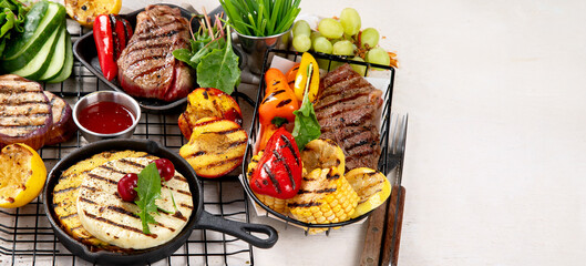 Grilletables and meat. Cooked steak, corn, pepper, peach on light background. Food concept