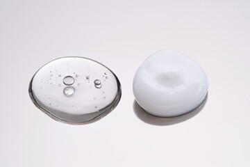 Facial serum and cream on a stainless steel surface. Texture.