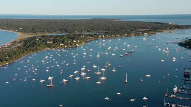 An aerial parallax shot of sailboats moored off Chappaquiddick Island in Martha's Vineyard, Massachusetts