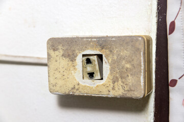 Old broken electrical socket fell out of box.