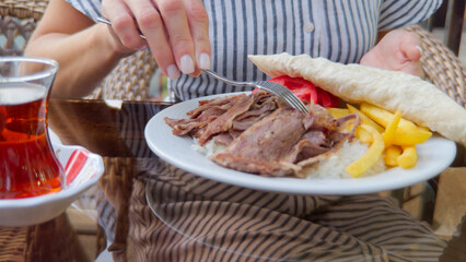 Woman Enjoying Turkish Meal with Tea at an Outdoor Cafe, Tashkent, Uzbekistan