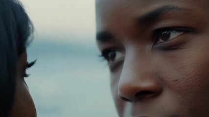 Young man and woman are sharing a tender moment, their eyes locked in a gaze that speaks volumes about their connection