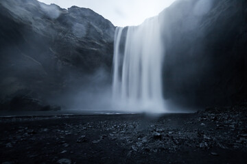 skogafoss waterfall, iceland, huge waterfall, evening time, long exposure, handheld photo, black...