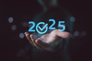 Set goals quality for 2025, businessman holds text 2025, service and quality, implementation of...