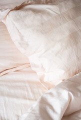 Soft pillows and bedding on bed creating cozy and inviting atmosphere.