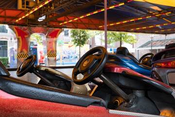 Empty bumper cars at a funfair, waiting for customers