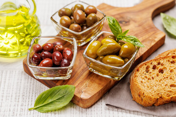 An assortment of various olives presented in a bowl, showcasing different colors, textures, and flavors