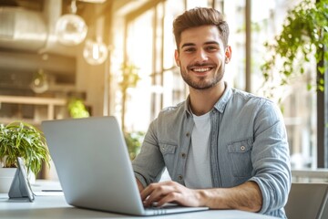 Fototapeta premium High-resolution brightly lit photorealistic candid photograph of a young marketer in casual attire, smiling while working on his laptop in a bright office. The photograph is styled like a high-end