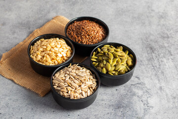 pumpkin seeds, flaxseeds, watermelon seeds, sunflower seeds, sabja seeds, chia seeds on bowls, for...