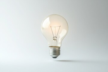 Minimalistic image of a single light bulb glowing faintly against a white background, symbolizing ideas, creativity, and innovation.