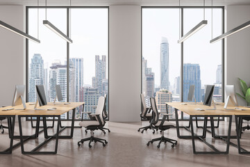 Office coworking interior with pc monitors in row, panoramic window