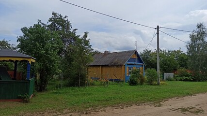 Russian wooden house with a fence on the street in the village