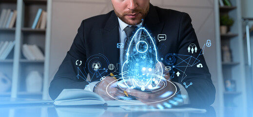 Businessman taking notes in office room, rocket hologram with icons