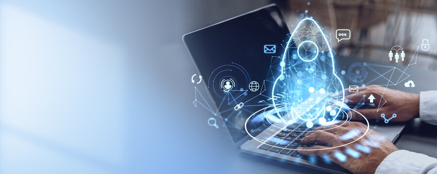 Man typing in laptop, rocket hologram with business icons. Copy space