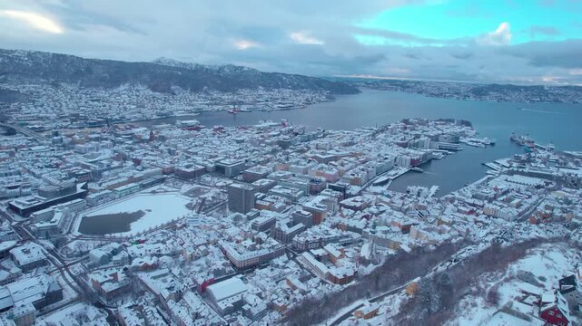 Drone over bergen, norwegian city Aerial during wintertime, sea fjord harbor visible, Norway Winter