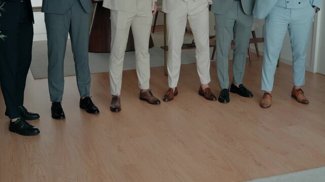 Groomsmen lined up, showcasing their stylish suits and polished shoes