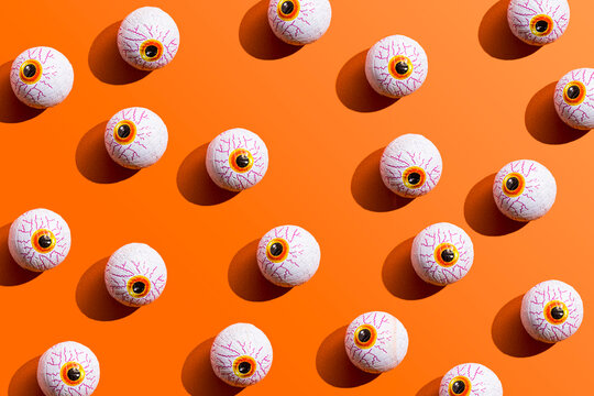 Halloween candy with eyeball wrapping against orange background