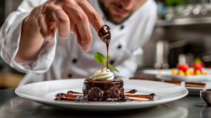 Chef garnishing chocolate dessert with caramel sauce