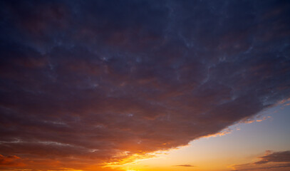 Dramatic Colorful Sunset Sky. Clouds with Sunrays. Cloudscape Sunset Background. Panorama Sky. Dramatic sky with clouds at sunset or sunrise. Sunset Sundown. Sky with colorful clouds.