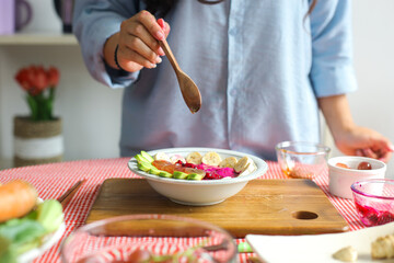 Close Up Of Woman Hand Holding Spoon While Adding Honey Into Mix Fruit