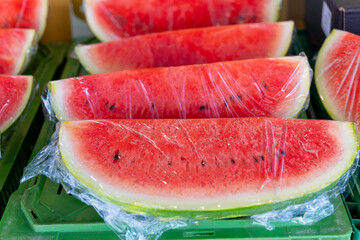 bunch of watermelon slices are wrapped in plastic
