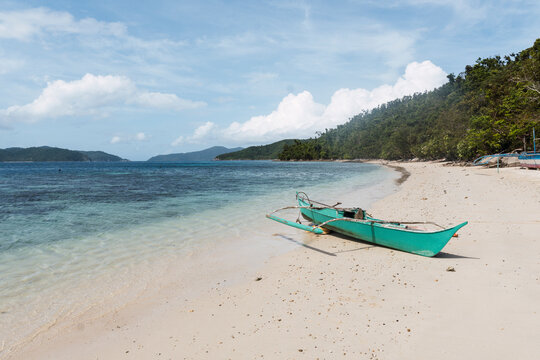 Bangka boat moored at Port Barton Beach near sea