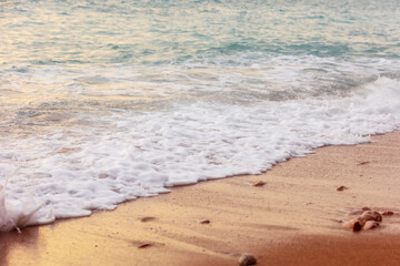Wave splashes close-up, sunset sea background