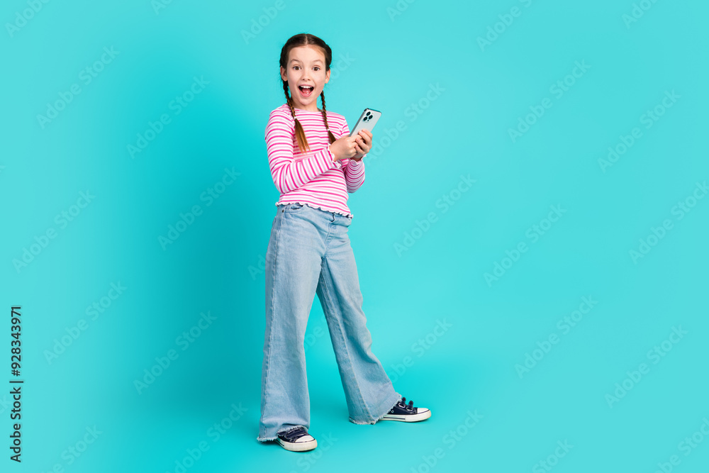 Wall mural photo of cute excited cheerful girl daughter wear trendy pink clothes use gadget isolated on cyan co