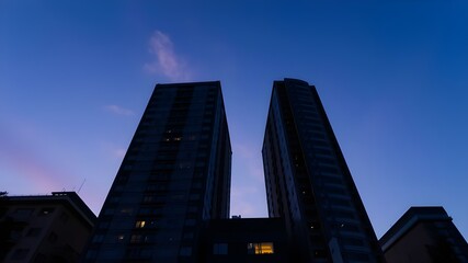 Fototapeta premium Bottom view of central business district with amazing twilight sky