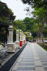 garden atmosphere with chairs and lamp pillars