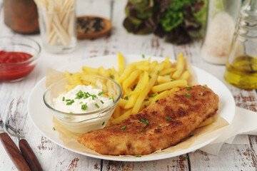 Fish and chips served on the plate, traditional dish of Great Britain	