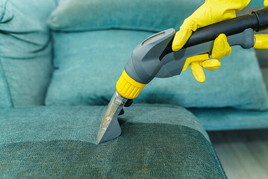 Close up of wet dry vacuum clean on dirty couch. Wet clean of before and after. Free space for text for cleaning business
