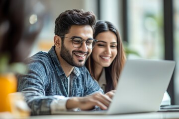 Indian asian young CEO businessman working with female colleague in the office using laptop computer, Generative AI