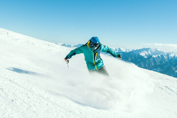 Professional caucasian skier at full speed ski downhill fast motion spray on fresh snow do carving...
