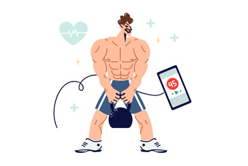Muscular man is engaged in strength sports, lifting weights and using fitness application on phone