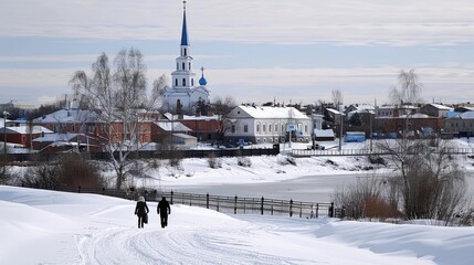 Fototapeta premium A serene winter landscape shows snow-draped trees next to the river, with a historic church tower rising above the icy waters under a bright sky