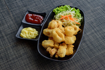 calamari rings Deep fried squid with classic ketchup and creamy mayonnaise, ready to satisfy your snack cravings.