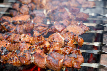 Shashliks are fried on the grill. Fried meat on skewers. Weekend meat barbecue.