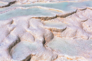 Stunning view of Pamukkale travertines with their unique terraced formations and crystal-clear...