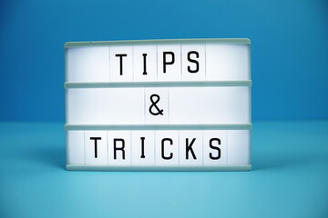 Tips & Tricks letterboard text on LED Lightbox on blue background