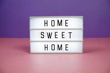 Home Sweet Home letterboard text on LED Lightbox on pink and purple background