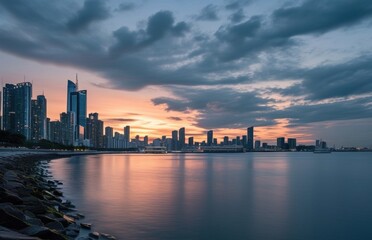 Fototapeta premium City skyline at sunset reflected in water.