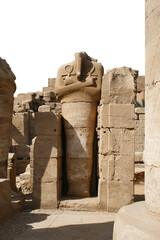 ruined headless statue in the guise of god Osiris in Karnak Temple Complex. isolated on a...