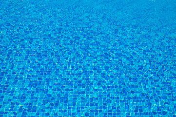 Abstract view of bottom caustics of swimming pool with ripple and flow on water surface.