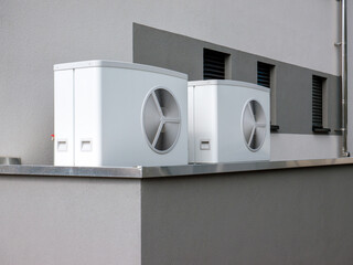 pair of heat pump outside on a modern building