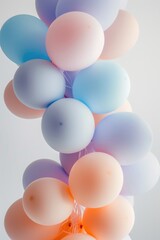 Colorful Pastel Balloons Cluster Against Light Grey Background