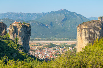Monasteries located on unique rock formations in the Meteora region of Greece are illuminated by...